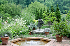 Formal garden pond fountain with girl statue